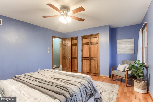 bedroom with ceiling fan and light hardwood / wood-style floors