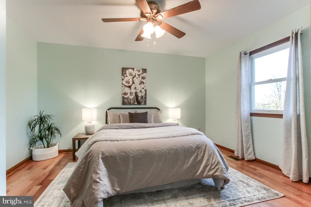 bedroom with ceiling fan and light hardwood / wood-style floors