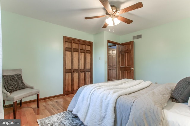 bedroom with ceiling fan, a closet, and light hardwood / wood-style flooring