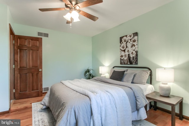 bedroom with ceiling fan and light wood-type flooring