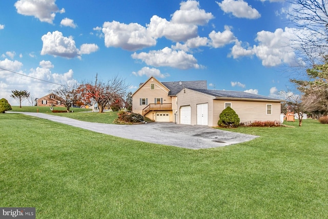 view of side of home with a lawn and a garage