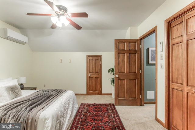 bedroom with light carpet, vaulted ceiling, ceiling fan, a wall unit AC, and a closet