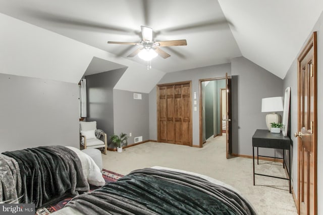 carpeted bedroom with ceiling fan and vaulted ceiling