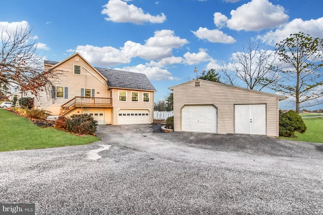 view of front of home featuring a garage and a wooden deck