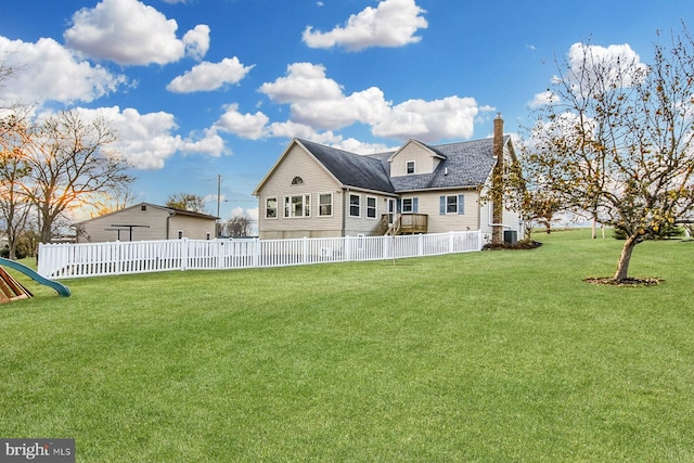 rear view of house featuring a yard