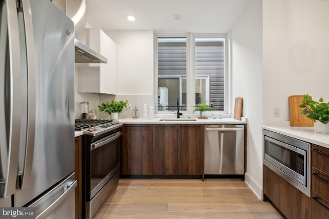 1513 Christian St Unit 5, Philadelphia, PA 19146 - kitchen featuring appliances with stainless steel finishes, a sink, modern cabinets, light wood finished floors, and recessed lighting