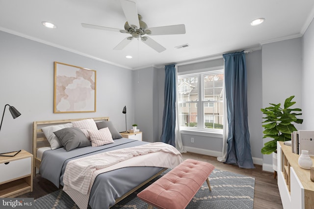 bedroom featuring ceiling fan, dark hardwood / wood-style flooring, and ornamental molding