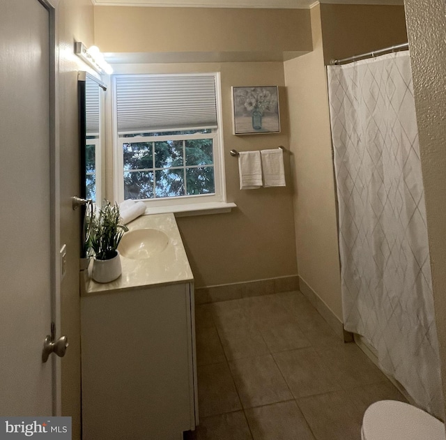 bathroom featuring tile patterned floors, vanity, and toilet