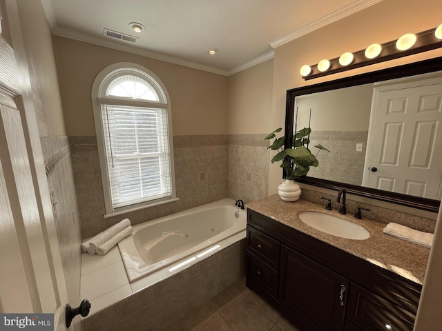 bathroom with tiled tub, tile patterned flooring, vanity, and ornamental molding