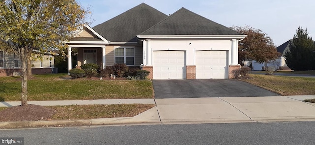 view of front of property with a garage and a front yard