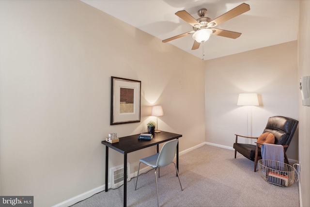 carpeted office with ceiling fan