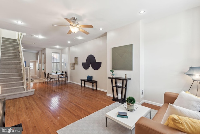 living room featuring ceiling fan and wood-type flooring