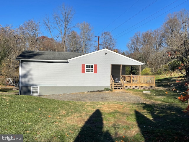 view of side of home with a lawn and a wooden deck