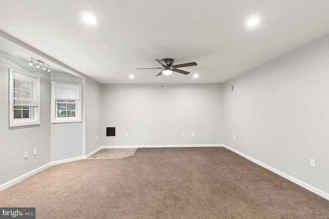 carpeted spare room featuring ceiling fan