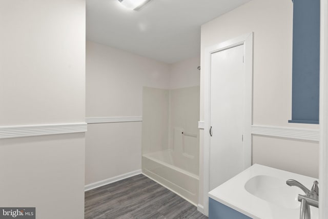 bathroom featuring vanity, wood-type flooring, and shower / tub combination