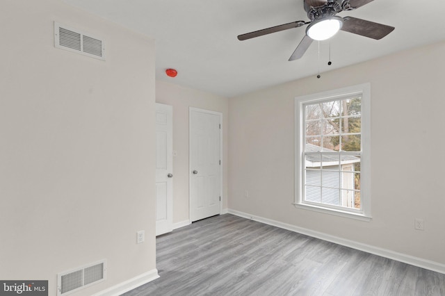 empty room featuring ceiling fan and light wood-type flooring