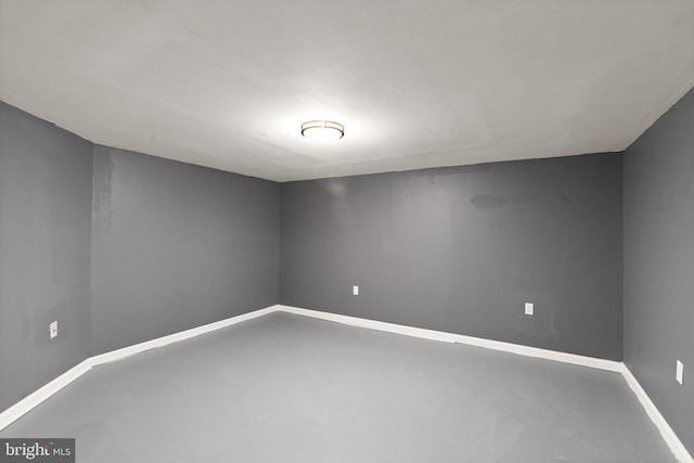 unfurnished room with concrete flooring