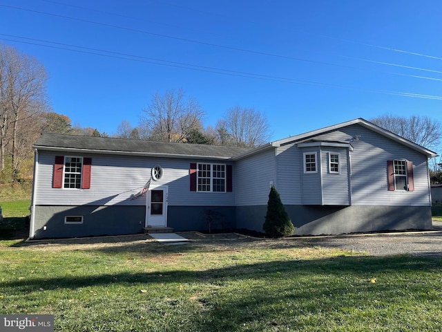 rear view of property with a lawn