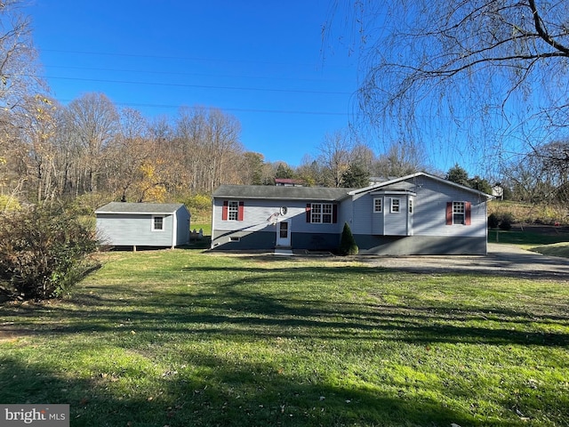 view of front of house featuring a front yard and a storage unit