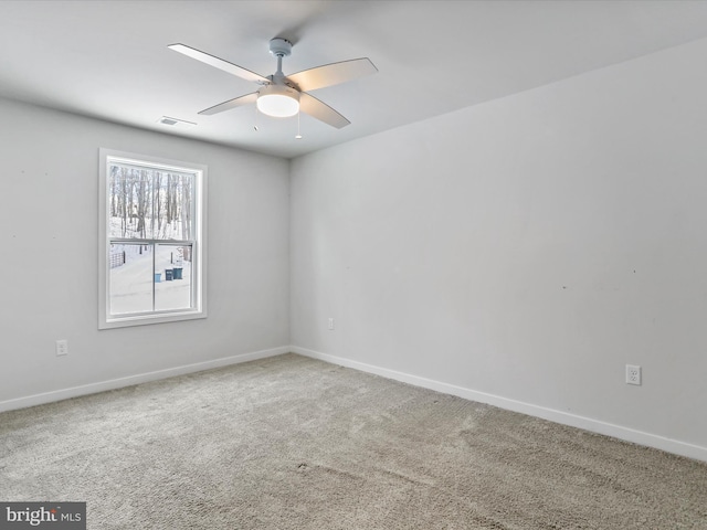 spare room featuring carpet and ceiling fan