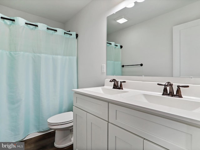 bathroom featuring hardwood / wood-style floors, vanity, and toilet