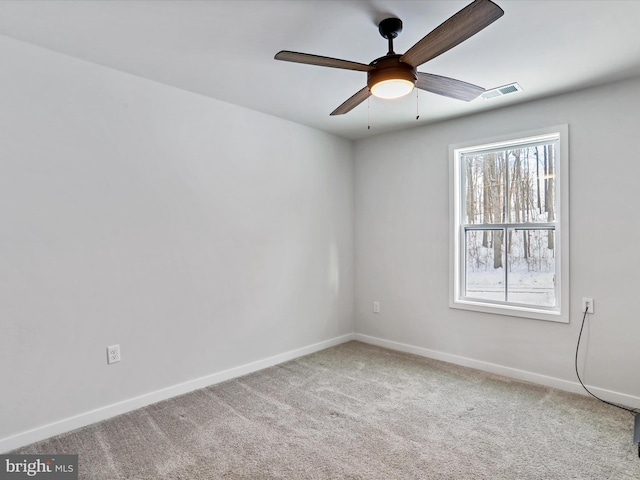 empty room featuring carpet flooring and ceiling fan