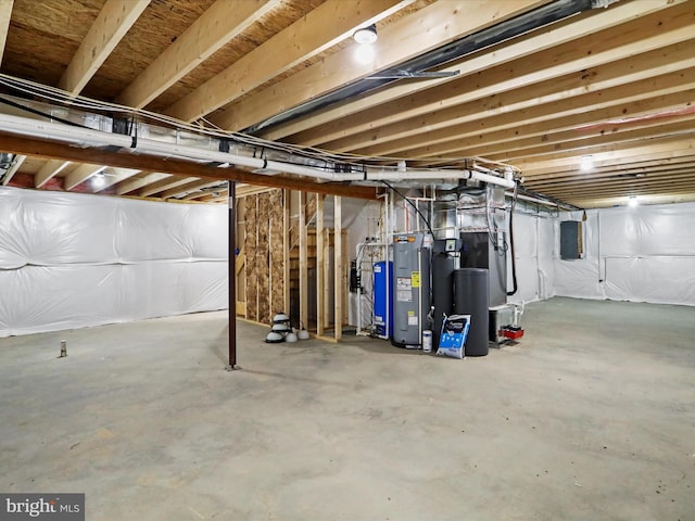 basement featuring electric panel and water heater