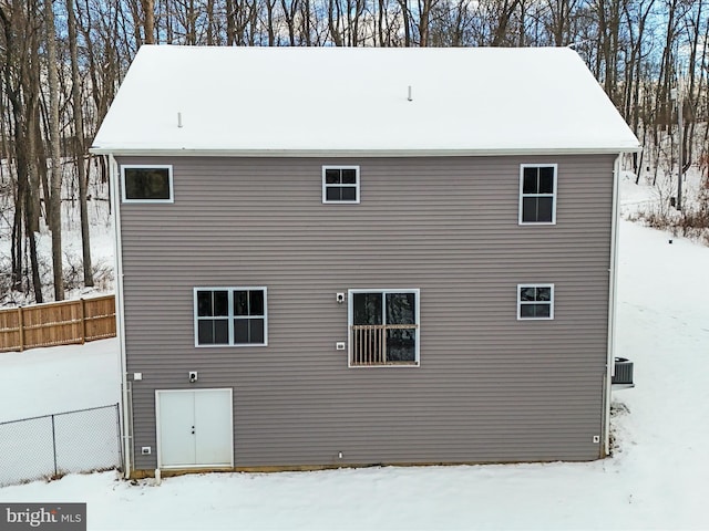 view of snow covered rear of property