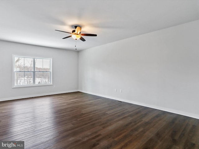 unfurnished room with ceiling fan and dark hardwood / wood-style flooring