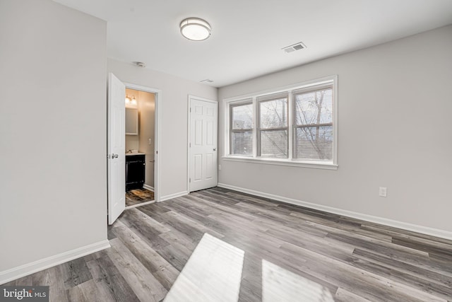 empty room with wood-type flooring