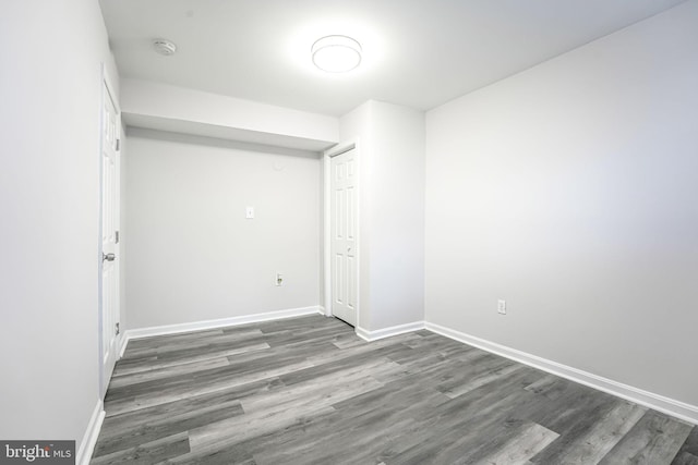 spare room with dark hardwood / wood-style floors