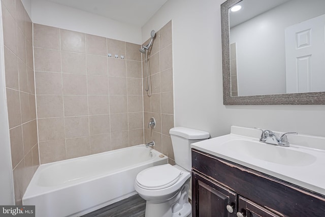 full bathroom featuring vanity, toilet, wood-type flooring, and tiled shower / bath