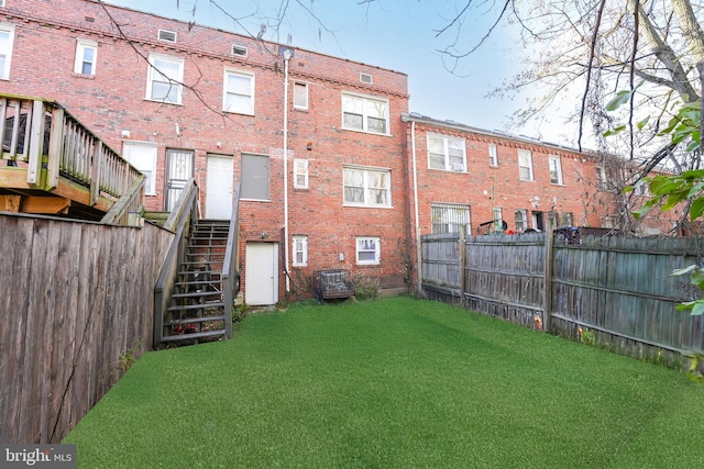 rear view of house featuring a yard