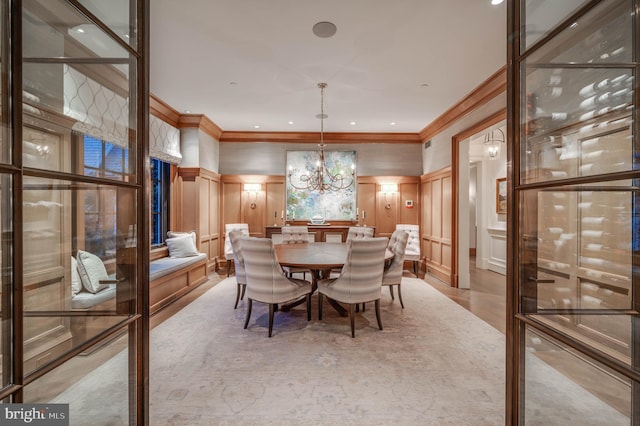 dining space featuring ornamental molding and an inviting chandelier