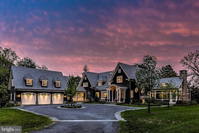 view of front of home featuring a garage and a lawn