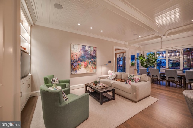 living room featuring beamed ceiling, wood-type flooring, and ornamental molding