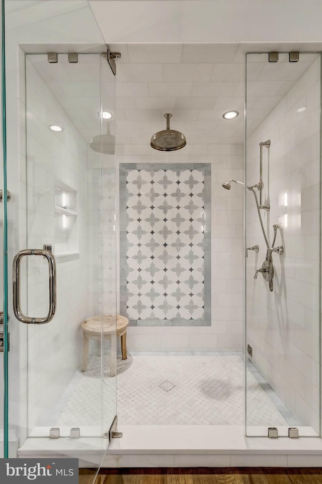 bathroom with a shower with door