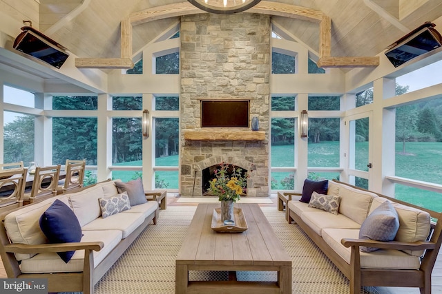 sunroom / solarium featuring a fireplace, vaulted ceiling with beams, and wooden ceiling