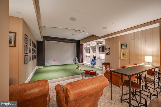 playroom featuring carpet, golf simulator, and wooden walls