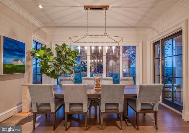 dining area with hardwood / wood-style floors, a healthy amount of sunlight, and ornamental molding