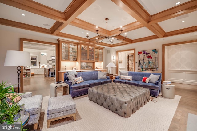 living room with beamed ceiling, coffered ceiling, and wet bar