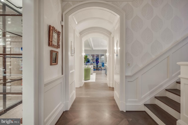 corridor with hardwood / wood-style flooring and crown molding