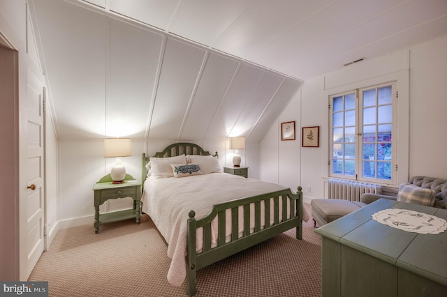 bedroom featuring radiator, carpet, and lofted ceiling