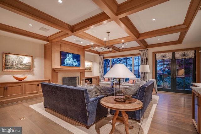 living room with light hardwood / wood-style floors, beam ceiling, and coffered ceiling