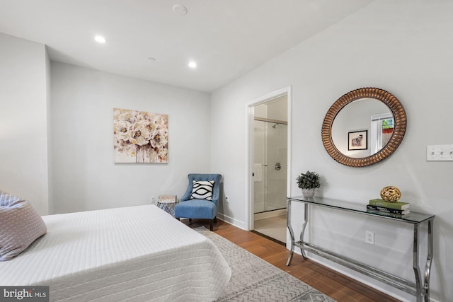 bedroom featuring connected bathroom and hardwood / wood-style flooring