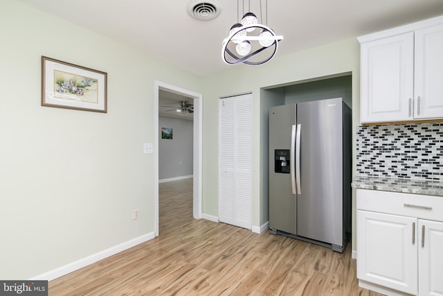 167 Shamrock Dr, Salisbury, MD 21804 - kitchen with stainless steel fridge, backsplash, light wood-type flooring, a chandelier, and white cabinetry