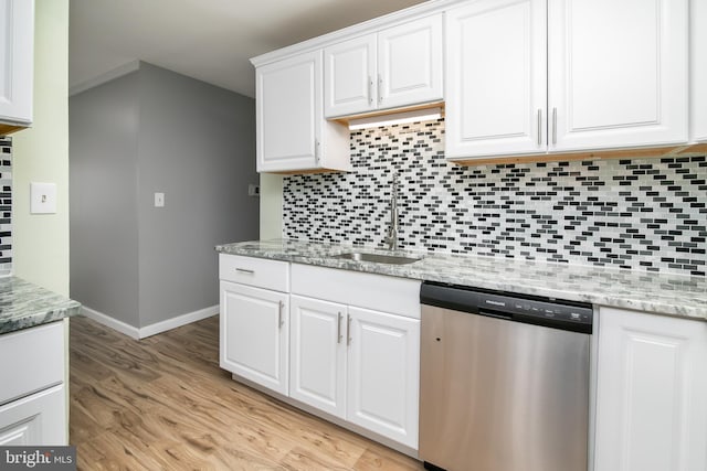 kitchen featuring decorative backsplash, sink, dishwasher, light hardwood / wood-style floors, and white cabinetry