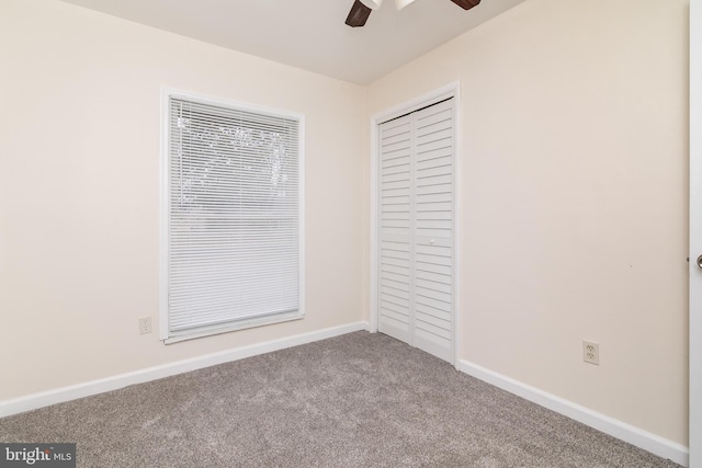 unfurnished bedroom with carpet floors, a closet, and ceiling fan