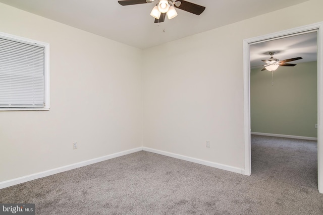 carpeted spare room with ceiling fan