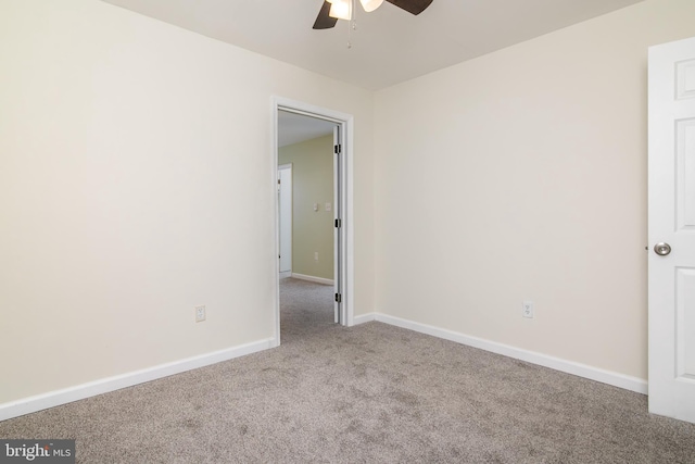 unfurnished room featuring light carpet